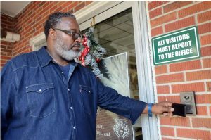 Ronald Barnes, School Violence Prevention Coordinator for Covington County Schools, uses a keycard in order to enter Carver Middle School in Collins, Friday, Dec. 9, 2022. Credit: Vickie D. King/Mississippi Today