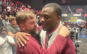 Cliff Little (left) and Mitchell McCurry embrace after McCurry's Louisville girls won the State 4A championship. (Photo by Rick Cleveland)