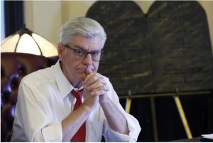 Gov. Phil Bryant ponders a response to a question regarding his legacy following a life of public service, while sitting in his Jackson, Miss., Capitol office, Jan. 8, 2020. (AP Photo/Rogelio V. Solis)