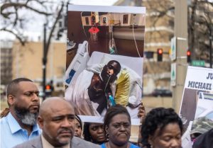 A photo of Michael Jenkins is held during a press conference near the University of Mississippi Medical Center in Jackson, Miss., Wednesday, Feb. 15, 2023. Jenkins' attorney said six Rankin County sheriff's deputies assaulted Jenkins and Terrell Parker. Jenkins sustained serious injuries. Credit: Eric Shelton/Mississippi Today