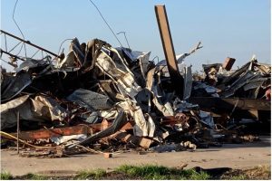 Debris covers a damaged structure in Rolling Fork, Miss,. on Saturday, March 25, 2023. Powerful tornadoes tore through the Deep South on Friday night, killing several people in Mississippi, obliterating dozens of buildings. (AP Photo/Rogelio Solis)
