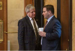 Rep. Donnie Scoggin, left, and Rep. Trey Lamar have a conversation during legislative session at the Capitol in Jackson, Miss., Thursday, March 23, 2023. Credit: Eric Shelton/Mississippi Today