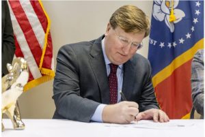 Gov. Tate Reeves signs qualifying paperwork to run for reelection at the Mississippi Republican Headquarters in Jackson, Miss., Tuesday, Jan. 3, 2023. Credit: Eric Shelton/Mississippi Today