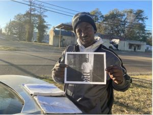 In his former hometown of Lambert, Miss., William Davis holds a picture Nov. 21, 2022, of himself as an inmate at the Mississippi State Penitentiary at Parchman. Credit: Elena DeBre/MCIR at Mississippi Today