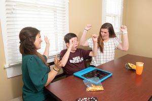 Hayden Smith, center, works with Megan Anderson, left, and Lyndsay Fairchild during a session at MSU’s Autism and Developmental Disability Clinic. The clinic and the T.K. Martin Center for Technology and Disability now will be under a unifying moniker, the new Mississippi Institute on Disabilities. (Photo by Beth Wynn)