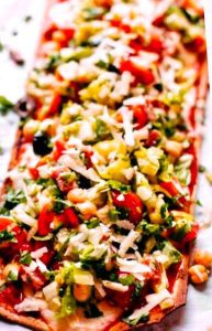 Homemade pizza topped with ground beef and favorite salad toppings creates an (almost) guilt-free experience - and it's delicious!