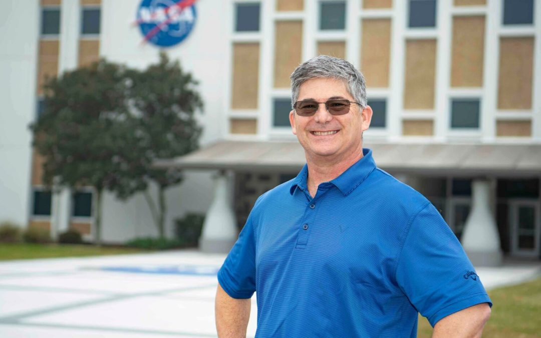 NASA Technical Manager Tom Lipski stands in front of the Roy S. Estess Building at NASA’s Stennis Space Center. The technical manager reviews new technology reports to ensure contract compliance. Additionally, he connects with university students in Mississippi and Louisiana to discuss NASA-proven technologies while encouraging entrepreneurship to use those technologies. Photo Credit: NASA/Danny Nowlin