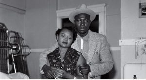 Mamie Till looks at the brutalized body of her son, Emmett Till. She is comforted by Gene Mobley, whom she would later marry. Credit: Photo by David Jackson