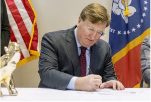 Gov. Tate Reeves signs qualifying paperwork to run for reelection at the Mississippi Republican Headquarters in Jackson, Miss., Tuesday, Jan. 3, 2023. Credit: Eric Shelton/Mississippi Today