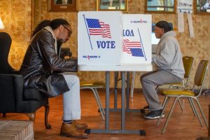 Lathan Whirl, left, and Sidney Harper fill out their ballots at Peoples Funeral Home in Jackson after voting during the Mississippi Senate runoff election Tuesday, November 27, 2018. Credit: Eric J. Shelton, Mississippi Today/ Report for America