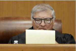 Hinds County Chancery Judge Dewayne Thomas studies his notes at a hearing, Wednesday, May 10, 2023, in Hinds County Chancery Court in Jackson, Miss., where he heard arguments about a Mississippi law that would create a court system with judges who would be appointed rather than elected. (AP Photo/Rogelio V. Solis)