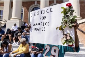 Carl Gray holds a sign during a press conference announcing the Hughes family lawsuit against Forrest County and law enforcement in the Forrest County Sheriff's Department, at the Forrest County Circuit Courthouse in Hattiesburg, Miss. Thursday, May 4, 2023. Credit: Eric Shelton/Mississippi Today