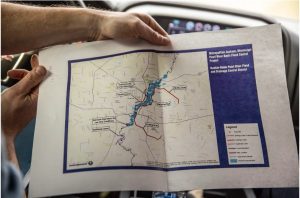 Dallas Quinn with Pearl River Vision Foundation holds a map of the proposed widening of the Pearl River for the One Lake. Credit: Eric J. Shelton, Mississippi Today/Report For America