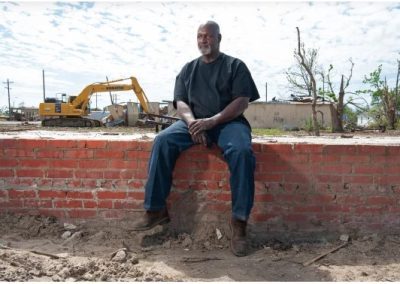 Sammie Jackson sits on all that remains of his house in Rolling Fork. Rory Doyle for NBC News