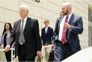 Mississippi Supreme Court Chief Justice Mike Randolph, left, and his attorney Ned Nelson, exit the Thad Cochran United States Courthouse in Jackson, Miss., Monday, May 22, 2023, for a lunch break, during the first day in federal court where a judge is hearing arguments about a Mississippi law that would create a court system with judges who would be appointed rather than elected. (AP Photo/Rogelio V. Solis)