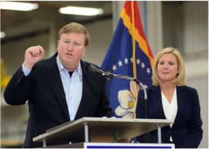 Gov. Tate Reeves, with his wife Elee Reeves, spoke to supporters at Stribling Equipment in Richland on Wednesday, May 3, 2023. Credit: Vickie D. King/Mississippi Today
