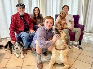 Jim Mabus, left, is pictured with his family at Christmas family photo left to right, daughter-in-law Mary Katherine Mabus, son Jake Mabus, and Denver Mabus with Donna Echols' dogs Credit: Courtesy of Donna Echols