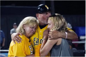 Southern Miss baseball coach Scott Berry, center, hugs his wife Laura Berry, left, and kisses his daughter Kitty Berry, following his team's 5-0 loss to Tennessee during an NCAA college baseball Super Regional game Monday, June 12, 2023, in Hattiesburg. Berry had previously announced his retirement at the conclusion of the season. (AP Photo/Rogelio V. Solis)