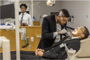 Brielan Terrell, center, and Clayton Neely participate in a dentistry exercise during the Black Men in Health Care Empowerment Summit at University of Mississippi Medical Center on Saturday, June 10, 2023. Credit: Eric Shelton/Mississippi Today