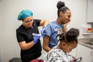 Registered nurse Terri Tolerations, left, gives Tiffany Wells a shot for her pregnancy at Lakeland Premier Women's Clinic February 13, 2020. Credit: Eric J. Shelton/Mississippi Today, Report For America