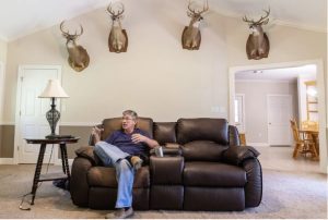 Roger Stringer sits in his living room as he talks about the audio memoir he made with his son, Zachary Stringer, in Columbia, Friday, July 7, 2023. Their audio memoir, Something Ain't Right, tells the story of when Roger's youngest Justin was shot by a riffle with a faulty trigger, which sent Zachary to prison