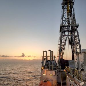 The drilling derrick of the scientific drilling ship JOIDES Resolution during sunset. Photo credit: Fengping Wang