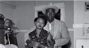 Mamie Till looks at the brutalized body of her son, Emmett Till. She is comforted by Gene Mobley, whom she would later marry.