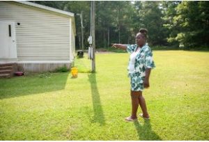 Monica Lee points to the side of her house where she alleges the Rankin County Sheriff’s Department beat her son, Damien Cameron, on July 30, 2023. Lee claims the department used excessive force and delivered life-ending injuries to her 29-year-old son in 2021.
