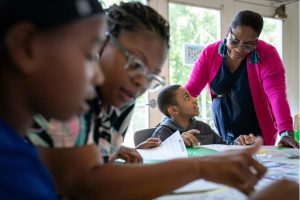 Nine-year-old Tyler works with a teacher at the Read to Succeed summer camp sponsored by the Mississippi Children’s Museum. Rory Doyle for The Hechinger Report