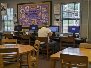 A resident uses a computer and internet at Utica community library