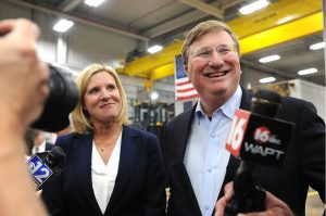 Gov. Tate Reeves, with his wife Elee Reeves, answer questions from the media after a campaign rally held at Stribling Equipment in Richland, Wednesday, May 3, 2023. Credit: Vickie D. King/Mississippi Today
