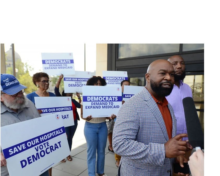 Mississippi Democratic Chairman Cheikh Taylor (second right), State Rep. Daryl Porter (right) and Democrat supporters gathered at the Sillers Building to protest Gov. Tate Reeves unveiling of a hospital program, Thursday, Sept. 21, 2023. Credit: Vickie D. King/Mississippi Today