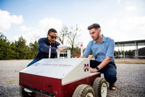 Charles Moore, left, a graduate computer science student from Harvest, Alabama, and Charles Raines, a senior computer science major from Cedar Bluff, make adjustments to an autonomous robot as part of their research opportunities at MSU's Institute for Clean Energy Technology. (Photo by Grace Cockrell)