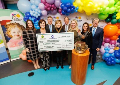 Showing the $1 million donation from the 2023 Sanderson Farms Championship are, from left, Caitlin Foreman, Friends of Children's Hospital executive director; Dr. Mary Taylor, Suzan B. Thames Chair and professor of pediatrics; Phillip Carpenter, Century Club Charities president; Dr. LouAnn Woodward, vice chancellor for health affairs and dean of the School of Medicine; Pic Billingsley, senior vice president and general manager of retail sales for Wayne-Sanderson Farms; Kristin Allen, Friends of Children's Hospital board chair; Hillary Burroughs, Wayne-Sanderson Farms director of marketing; and Steve Jent, Sanderson Farms Championship executive director.