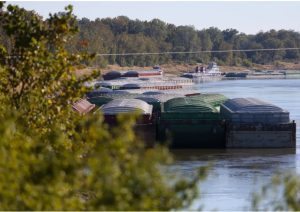 Barges on the Mississippi River sit on the other side of the levee from Mayersville, Miss., which lacks a port despite locals’ desire to develop one