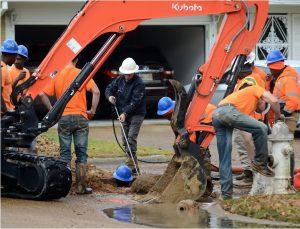 Workers with Gould Enterprises, LLC, JXN Water contractors, repair a water line at the t-section of Beacon Place and Queensroad Avenue in the Bel-Air subdivision in Jackson, Friday, Dec. 1, 2023.