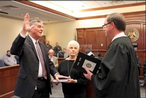 Rankin County Youth Court Judge Kent McDaniel, at left, takes the oath of office on Dec. 28 at the Rankin County Justice Center in Brandon. Rankin County Court Judge David Morrow, at right, administers the oath as Judge McDaniel’s wife JoAnn McDaniel holds the Bible.