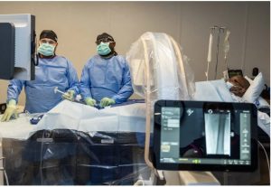 Radiology Technician Simon Burnham, left, and Dr. Foluso Fakorede perform an angiogram on a diabetes patient at Fusion Vascular in Cleveland, Miss., Wednesday, Nov. 29, 2023. Credit: Eric J. Shelton/Mississippi Today