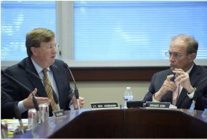 Mississippi Gov. Tate Reeves, left, discusses proposed revenue estimates with Lt. Gov. Delbert Hosemann, right, during a meeting of the Joint Legislative Budget Committee, Wednesday, Nov. 15, 2023, in Jackson, Miss. Reeves refused to approve top lawmakers' proposed revenue estimates because he believes a lower projection than he wanted would make it more difficult to justify future income tax cuts. (AP Photo/Rogelio V. Solis)