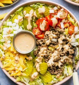 "Famous burger" salad is a great way to get the taste of a fast food burger without the bun, additives and other unhealthy ingredients.