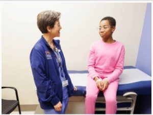 Dr. Melissa McNaull talks with Kennedi during a check-up at the Children’s of Mississippi Center for Cancer and Blood Disorders.