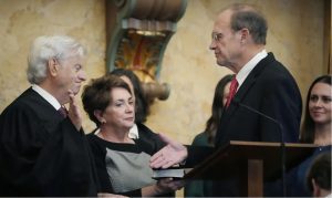 Mississippi Lt. Gov. Delbert Hosemann, right, shakes the hand of Mississippi Supreme Court Chief Justice Michael Randolph, after being administered the oath of office for his second term, Thursday, Jan. 4, 2024, in the House Chamber at the Mississippi State Capitol, in Jackson, Miss. (AP Photo/Rogelio V. Solis)