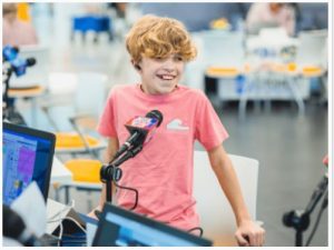Children's of Mississippi patient Aiden Robinson of Brandon smiles between interviews during the 2023 Mississippi Miracles Radiothon.
