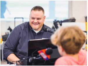 On-air personality and production director Fisher Alexander of U.S. 96 interviews Aiden Robinson during the 2023 Mississippi Miracles Radiothon.