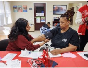 On the day before Valentine's Day, Elaine Jones, right, of Jackson gets her blood pressure checked by Student Health Coalition member Alka Ghadiyaram at Northwood Village Apartments during one of the coalition's many screening events.