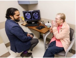 Georgia Pritchard of Sturgis in a follow-up visit has a conversation with Dr. Omar Chohan, associate professor of neurosurgery, after receiving laser interstitial thermal therapy for her persistent brain tumor.