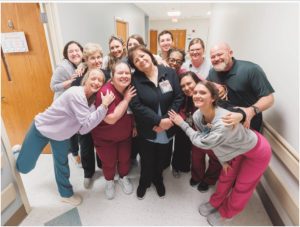 Farris poses with members of her team.