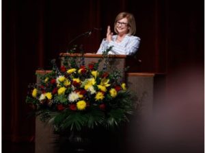 Dr. LouAnn Woodward, vice chancellor for health affairs and dean of the School of Medicine, applauds students' matches during the annual Match Day ceremony.