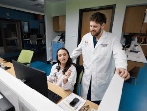 Gartrell talks with registered nurse Caroline Swayze at the pediatric intensive care unit in the Kathy and Joe Sanderson Tower at Children's of Mississippi.