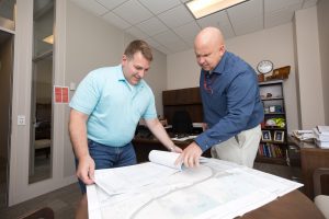 The U.S. Army Engineer Research and Development Center (ERDC) has four notable military construction (MILCON) projects that have been approved for construction in 2024.  Jack Wheeldon, ERDC’s chief of Installation Support Division, and Michael Harding, ERDC master planner, review the plans with an estimated construction cost of $43 million. (U.S. Army Corps of Engineers photo by Jared Eastman)